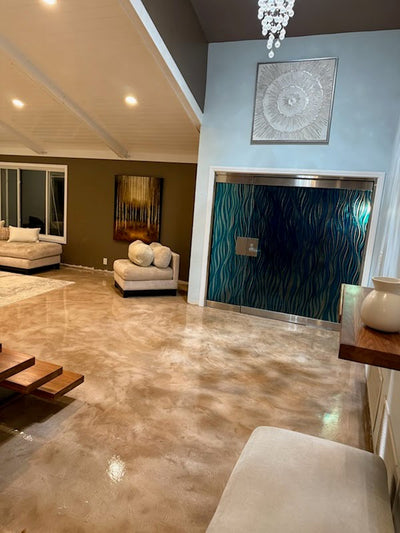 Real interior microcement-style floor made with Rhino Trowel-Top and finished with Rhino polyaspartic; warm tonal movement and a glossy finish.